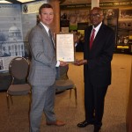 President Bob Methvin presents Fred David Gray with a framed copy of the resolutions.